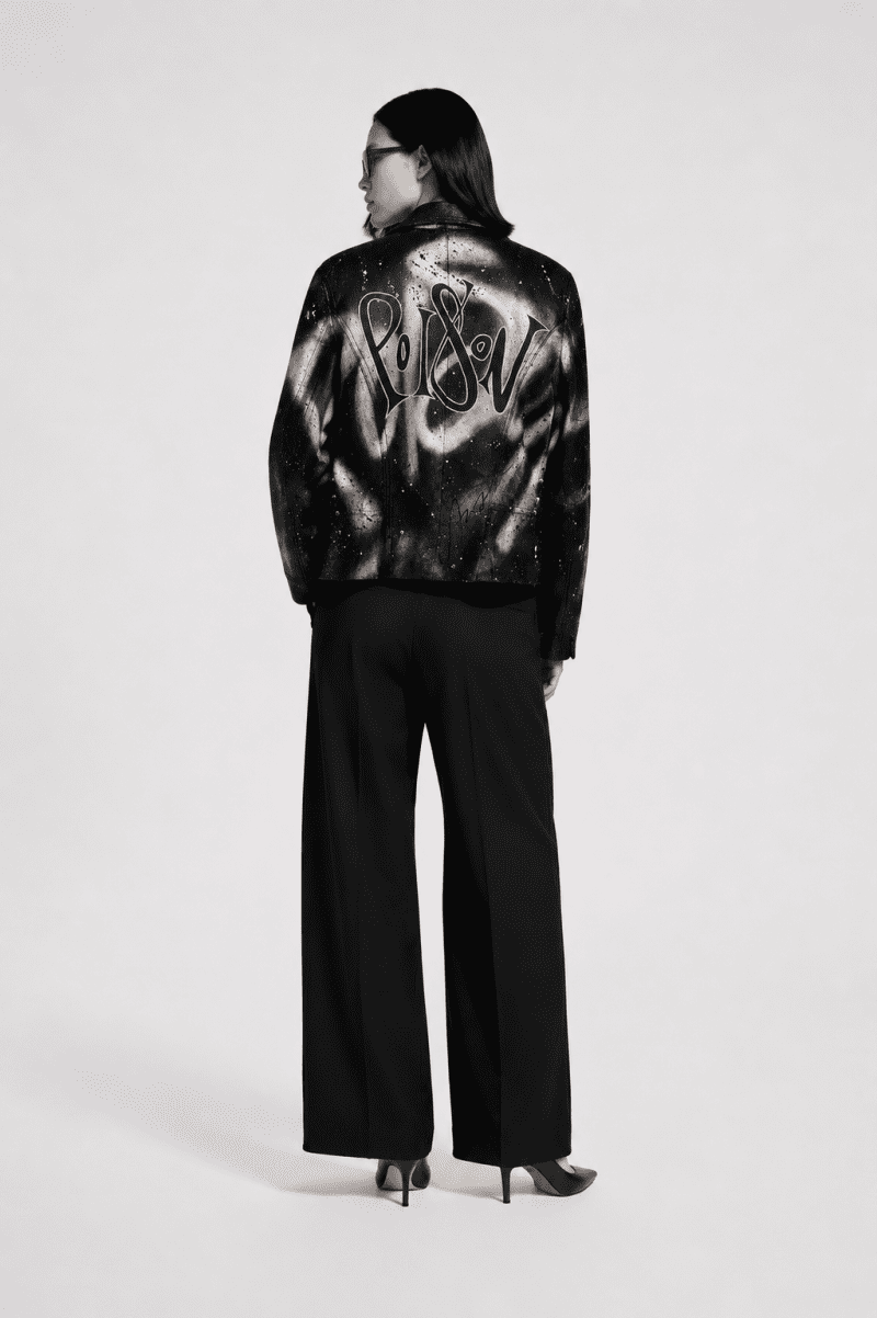 Back view of a hand-painted vintage Bison black leather jacket featuring the word "Poison" in custom calligraphy with abstract white brushstroke artwork.